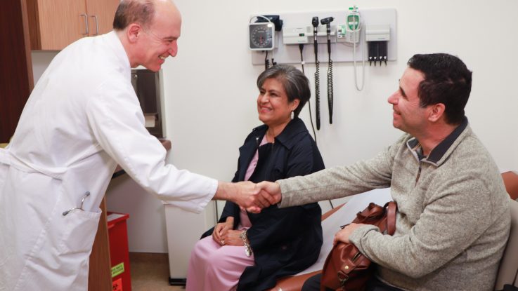Dr. Abbas Ardhali greets Miriam and Louie Merianos in a follow-up appointment at UCLA Health. Dr. Ardehali led a team that performed a successful double lung transplant on Miriam, whose complicated case was denied by more than 20 other transplant programs